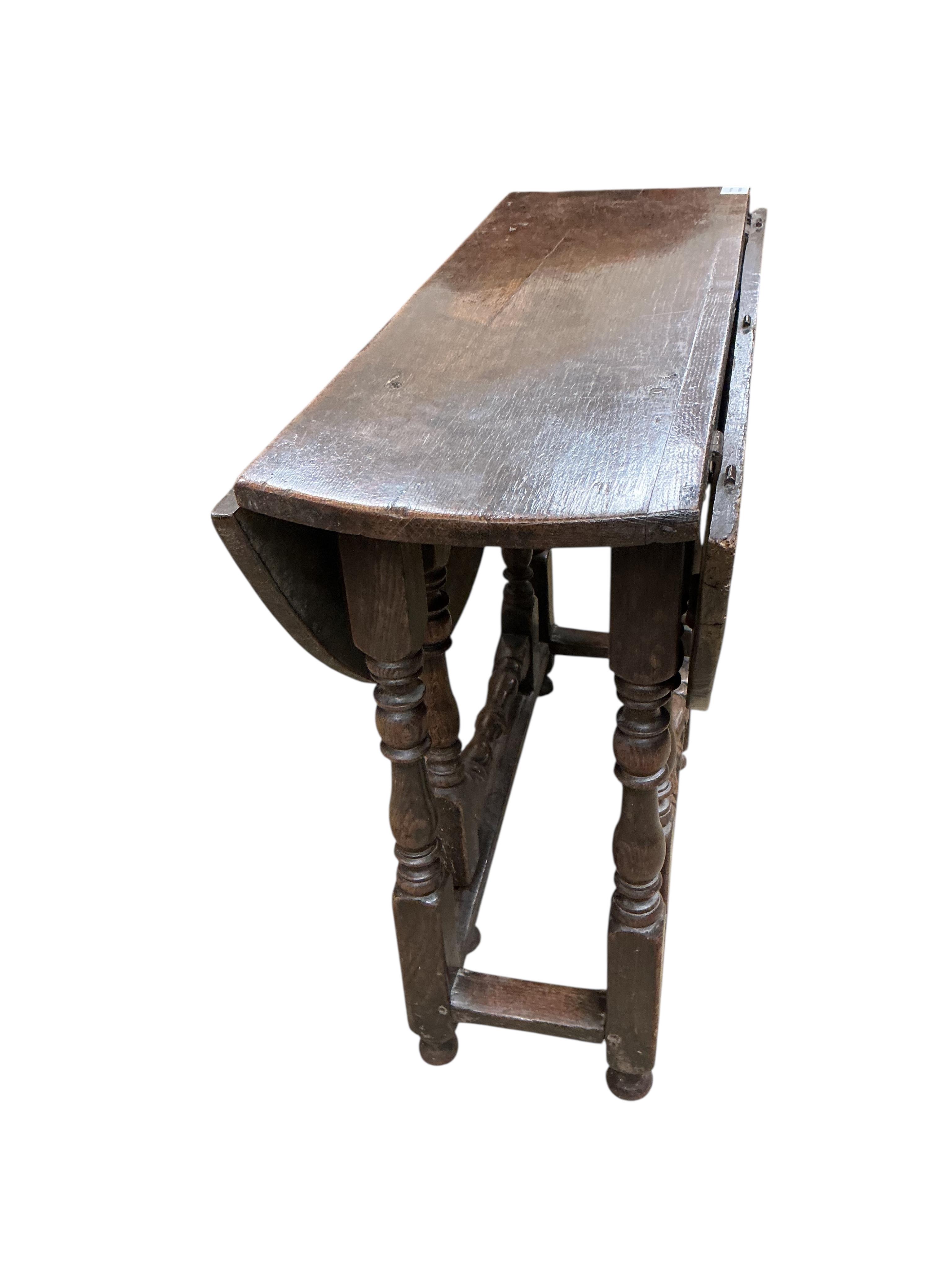 A small 18th century oval oak gate-legged table, width 92cm, depth 36cm, height 75cm
